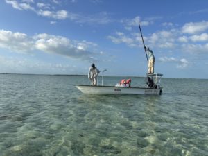 Bonefishing in the Bahamas, guide and angler on a flats boat ready to fish