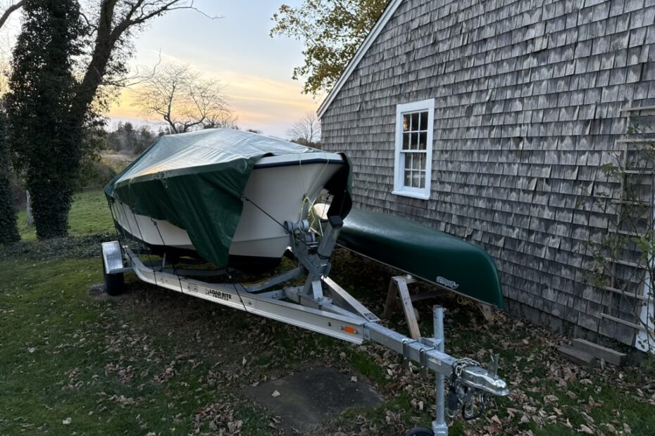 boat on a trailer with a green tarp on it